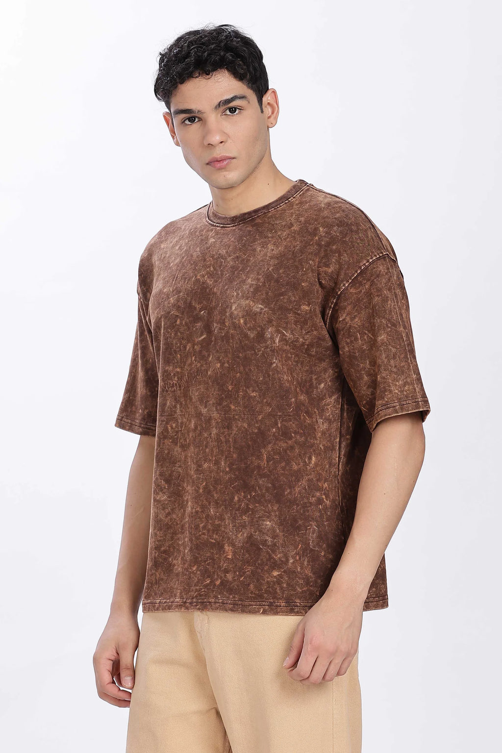 Man wearing a brown tie-dye t-shirt on a white background