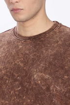 Close-up of a brown distressed sweater worn by a person