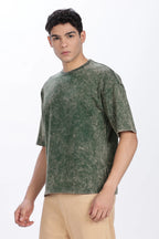 Man wearing a green distressed t-shirt on a white background