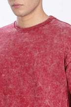 Red distressed sweatshirt worn by a person on a white background