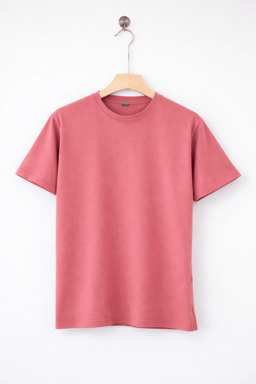Pink t-shirt on a wooden hanger against a white background