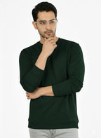 Man wearing a dark green sweater on a white background