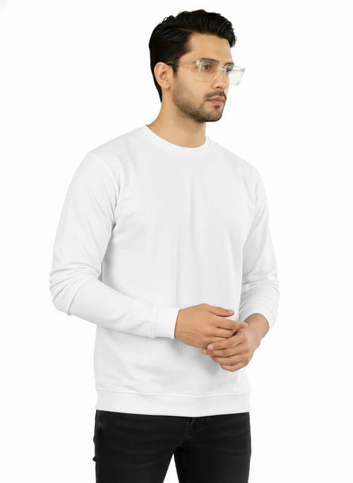 Man wearing a white long-sleeve shirt and black pants on a white background