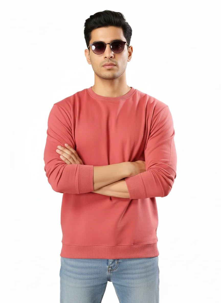 Man wearing a pink sweatshirt and sunglasses on a white background