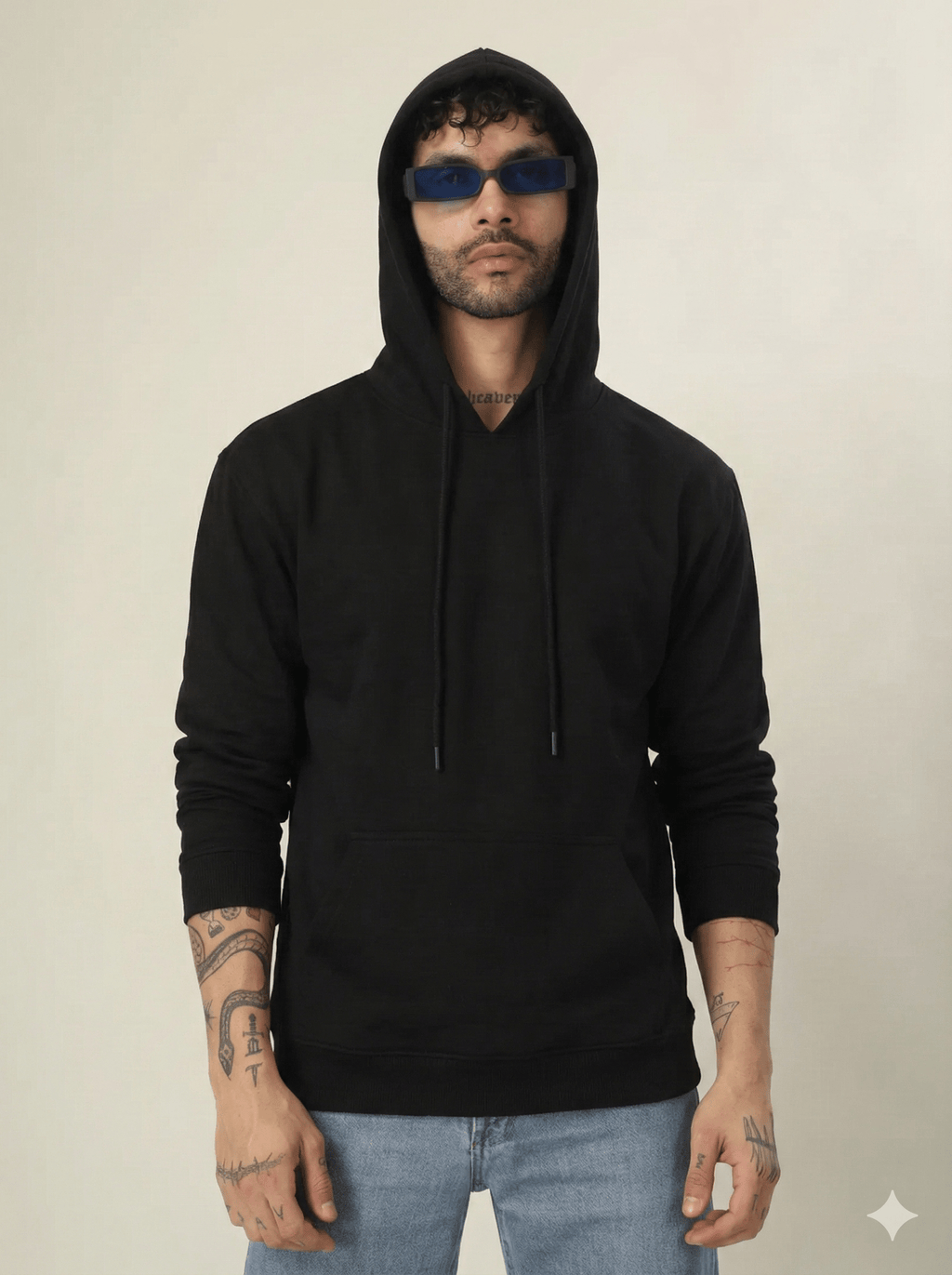 Person wearing a black hoodie and sunglasses on a plain background
