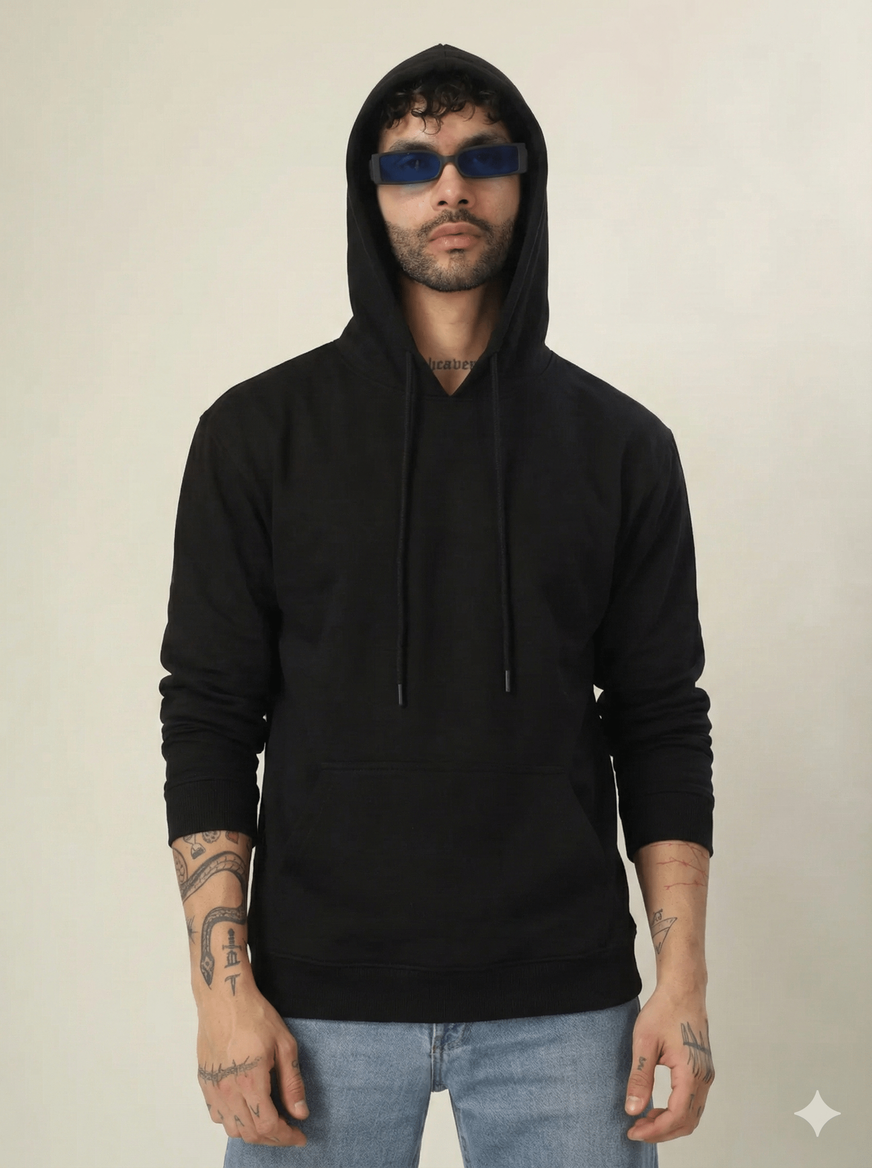 Person wearing a black hoodie and sunglasses on a plain background