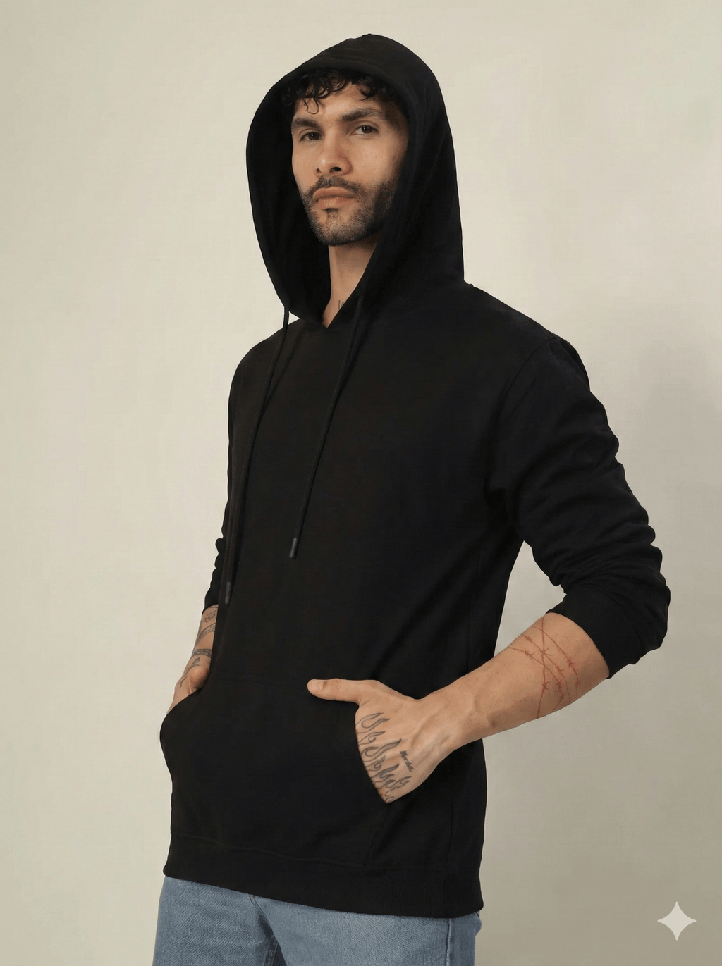 Man wearing a black hoodie against a plain background