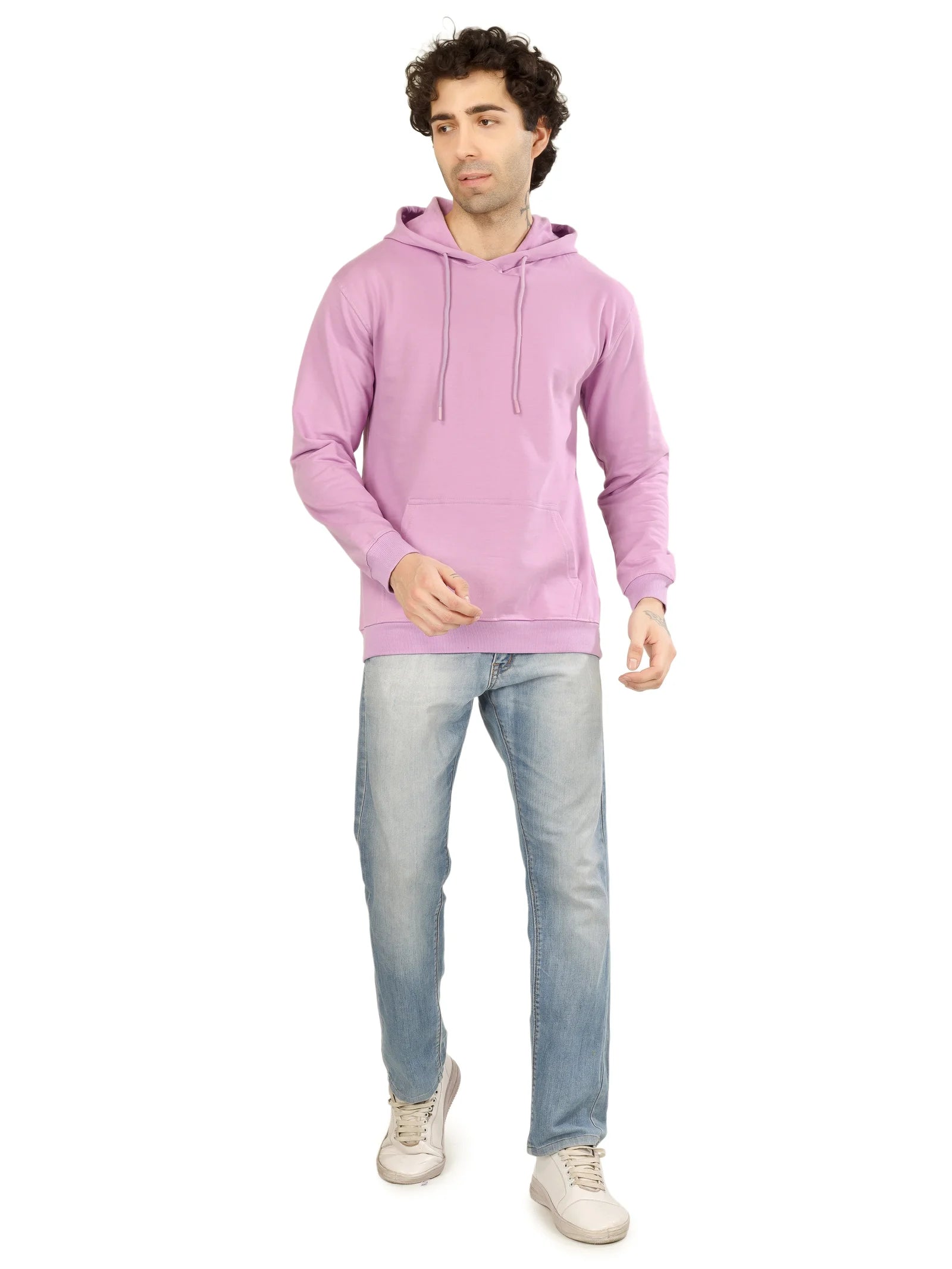 Man wearing a pink hoodie and light blue jeans on a white background