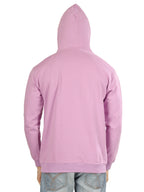 Pink hoodie worn by a person on a white background
