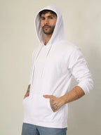 Man wearing a white hoodie against a plain background