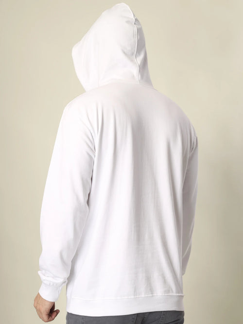 White hoodie worn by a person on a beige background