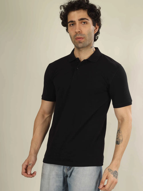 Man wearing a black polo shirt against a plain background