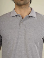 Gray polo shirt worn by a person on a plain background