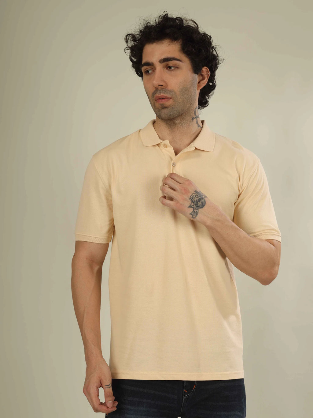 Man wearing a beige polo shirt against a plain background