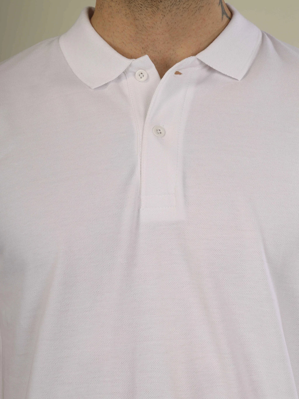 Close-up of a white shirt with a collar on a neutral background