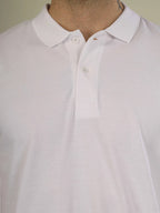 Close-up of a white shirt with a collar on a neutral background