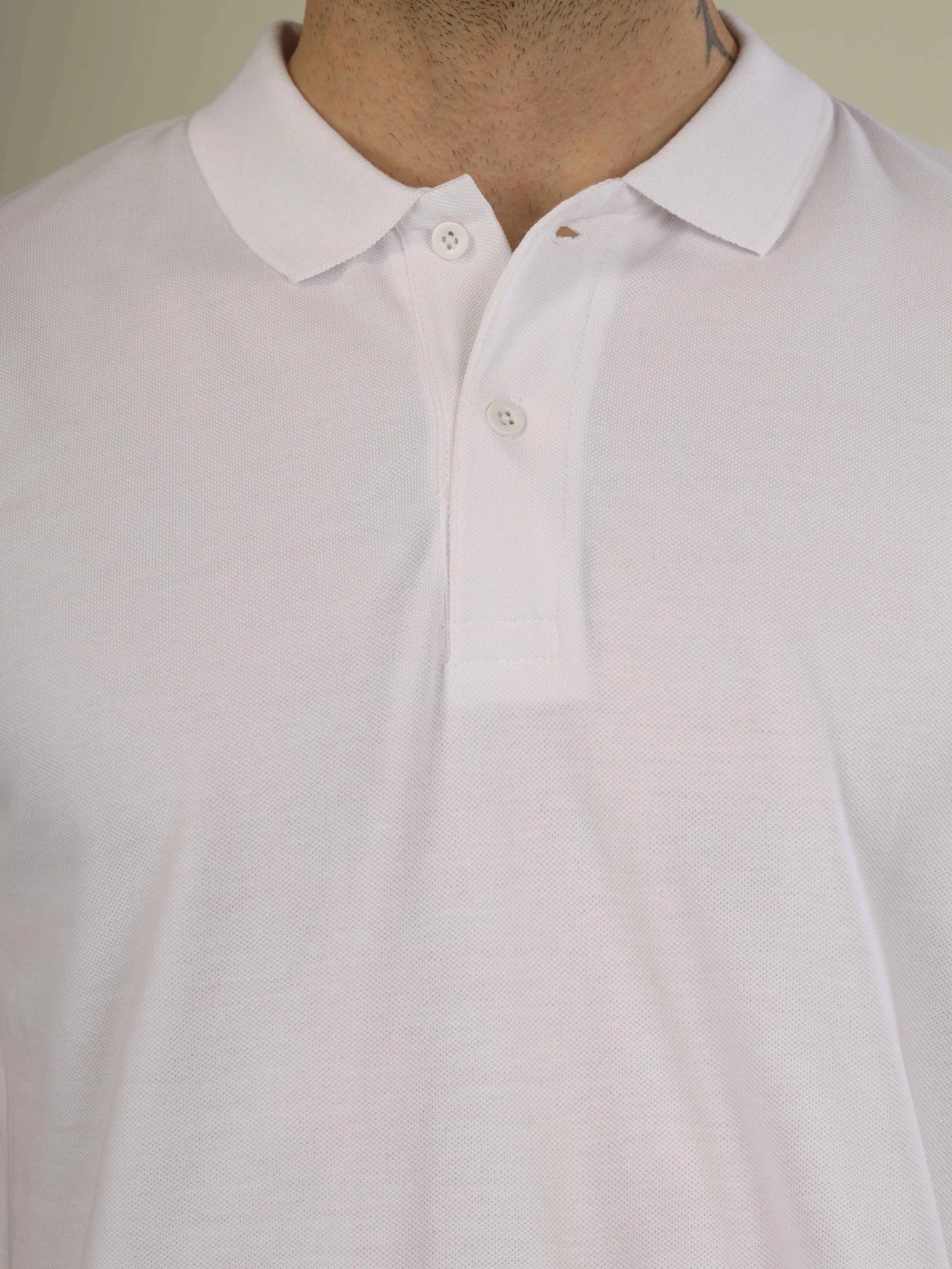 Close-up of a white shirt with a collar on a neutral background