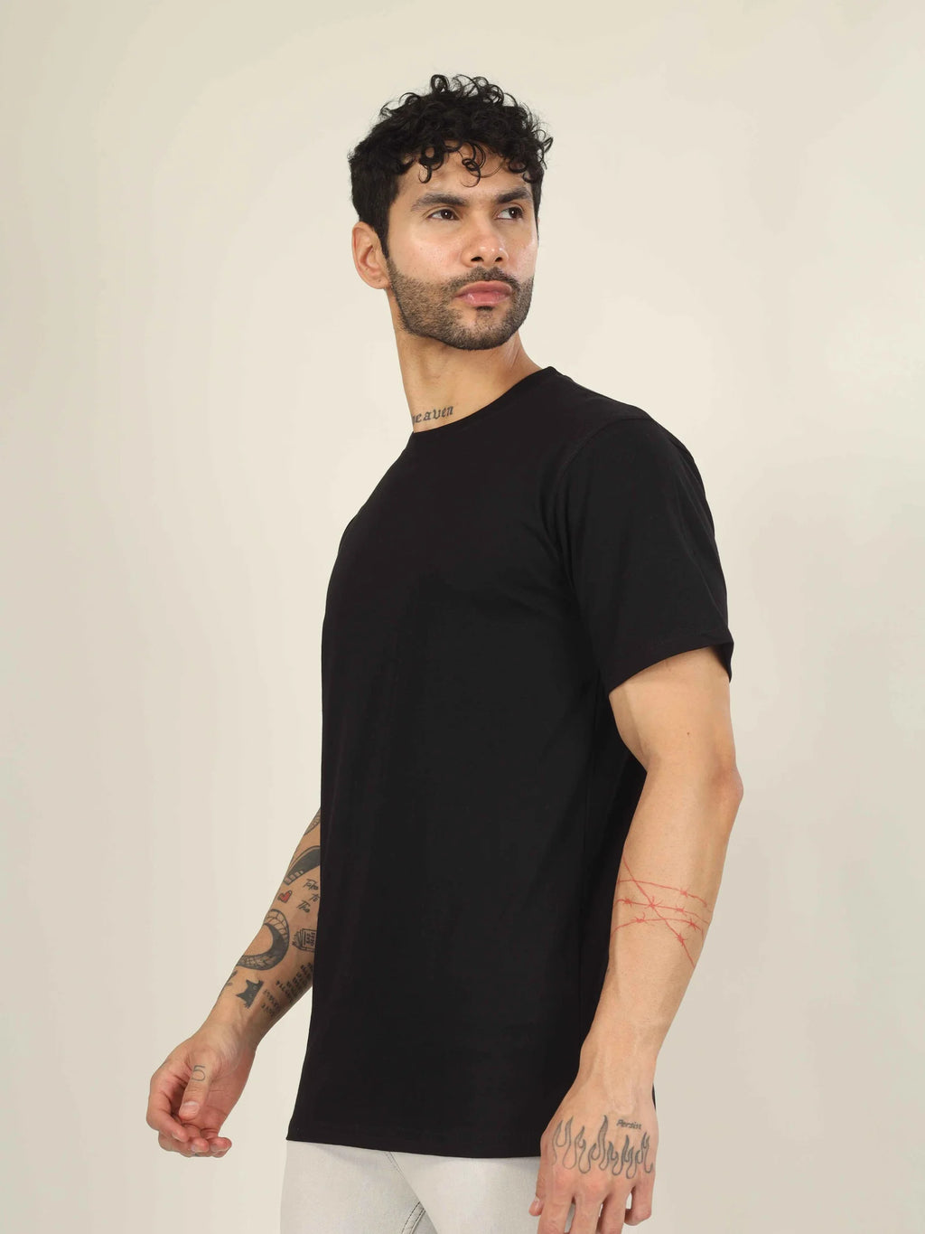 Man wearing a black t-shirt against a plain background