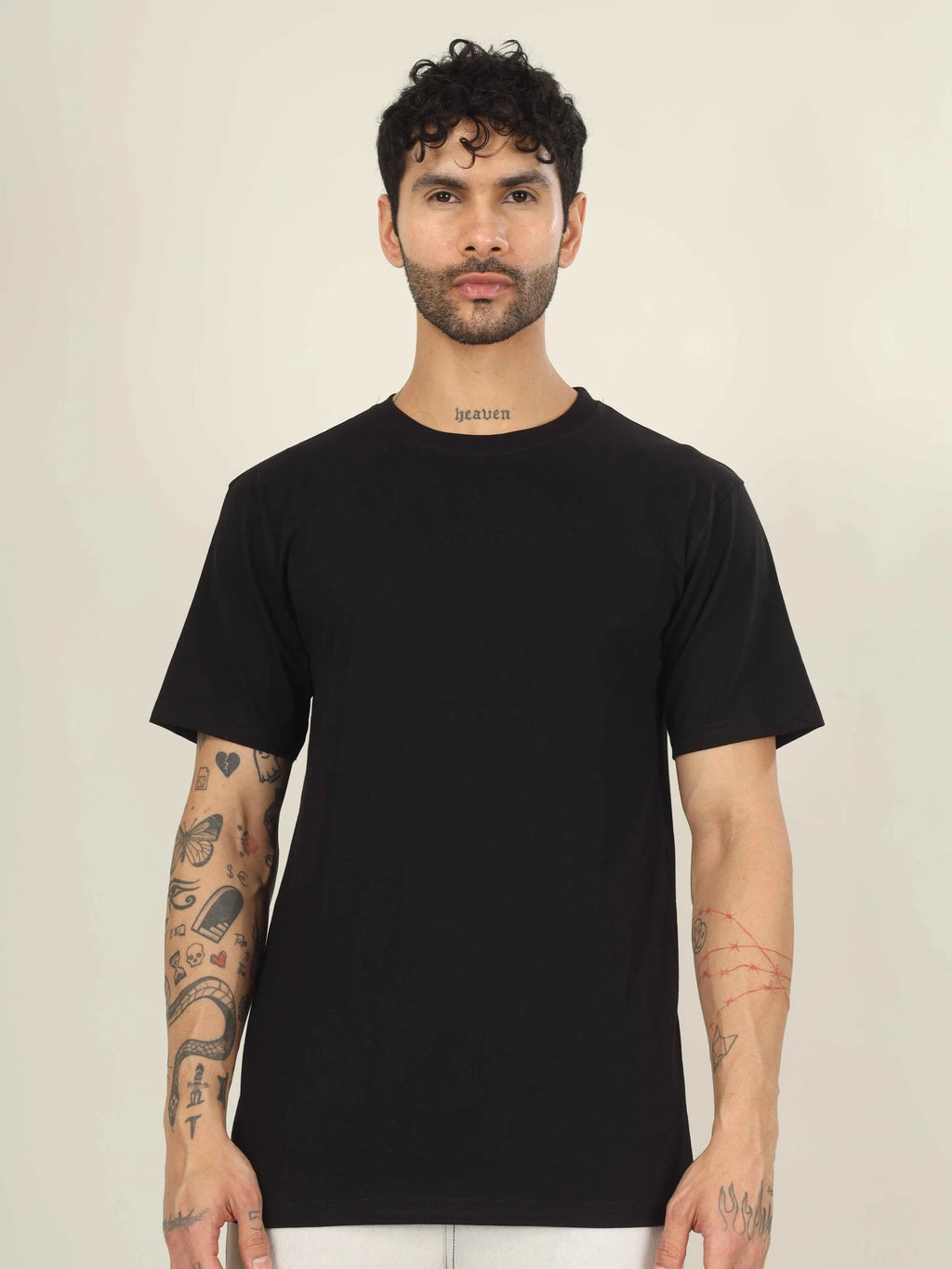 Man wearing a black t-shirt against a plain background