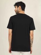 Man wearing a black t-shirt on a beige background