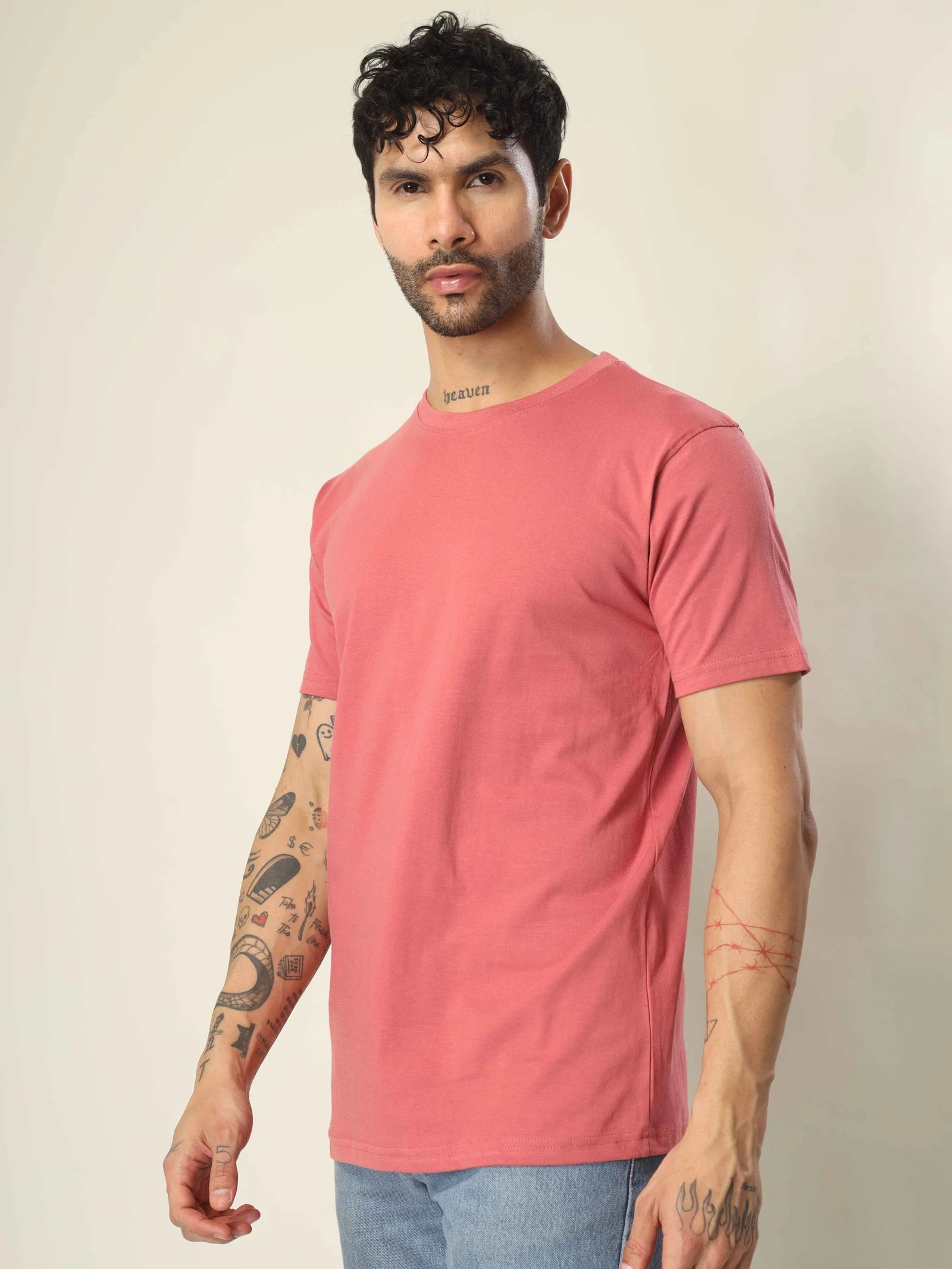 Man wearing a pink t-shirt against a plain background