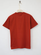 Red t-shirt on a hanger against a white background