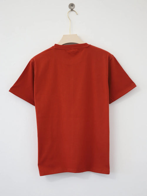 Red t-shirt on a hanger against a white background