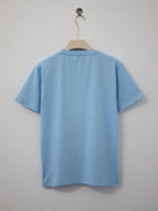 Light blue t-shirt on a hanger against a plain background