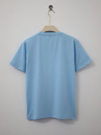 Light blue t-shirt on a hanger against a plain background