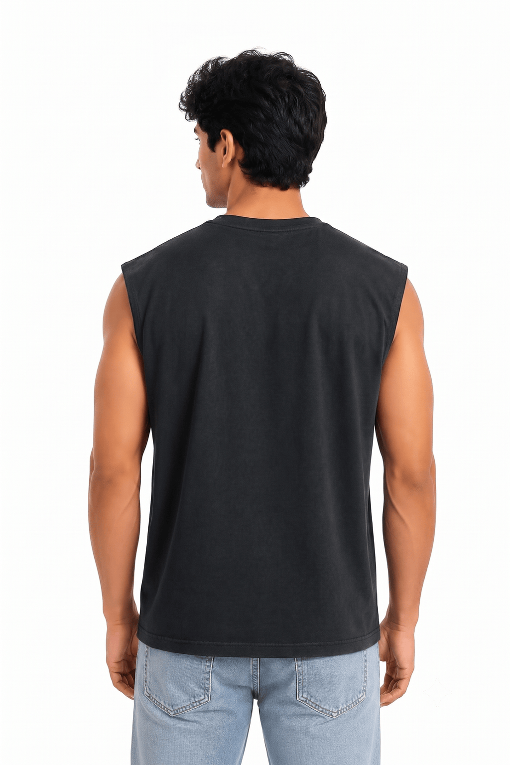A man viewed from the back wearing a black sleeveless muscle tank top and light blue jeans, standing against a solid white background.