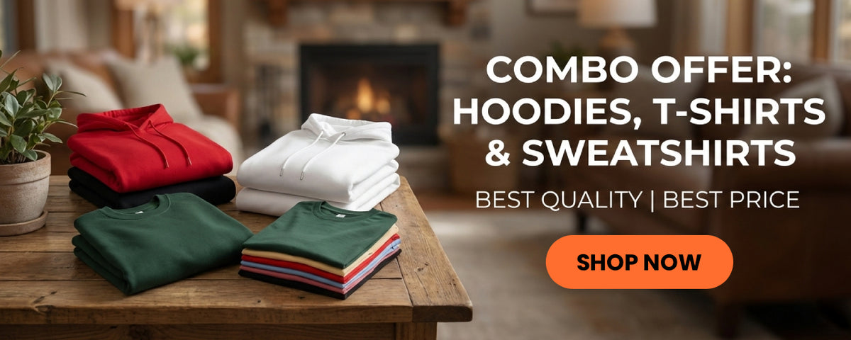 Clothing items including hoodies, t-shirts, and sweatshirts on a wooden table with a fireplace in the background.