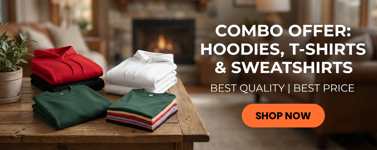 Clothing items including hoodies, t-shirts, and sweatshirts on a wooden table with a fireplace in the background.