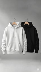 White and black hoodies on hangers against a gray background